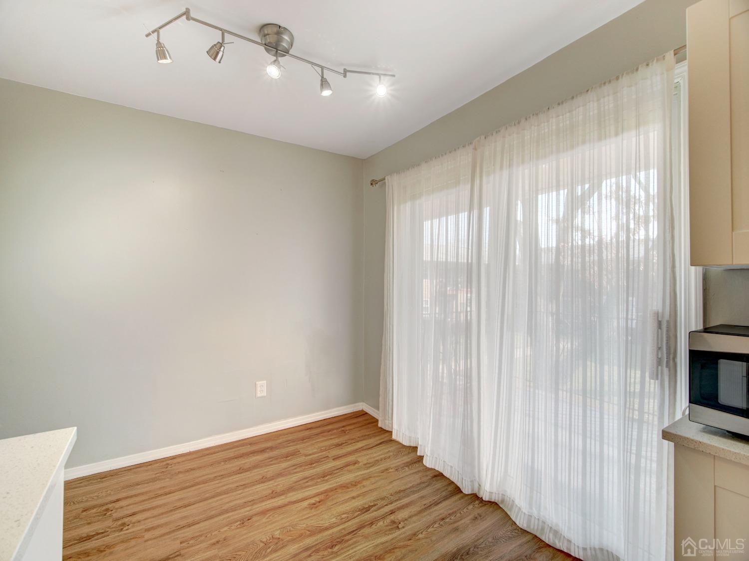 57 Judson Street, Unit 10B Edison, NJ 08837 - Photo 12 of 25 a view of a livingroom with wooden floor and a window