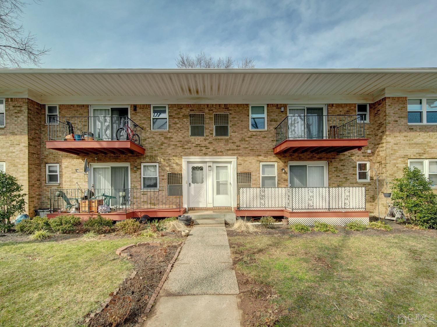 57 Judson Street, Unit 10B Edison, NJ 08837 - Photo 22 of 25 front view of a brick house with a yard