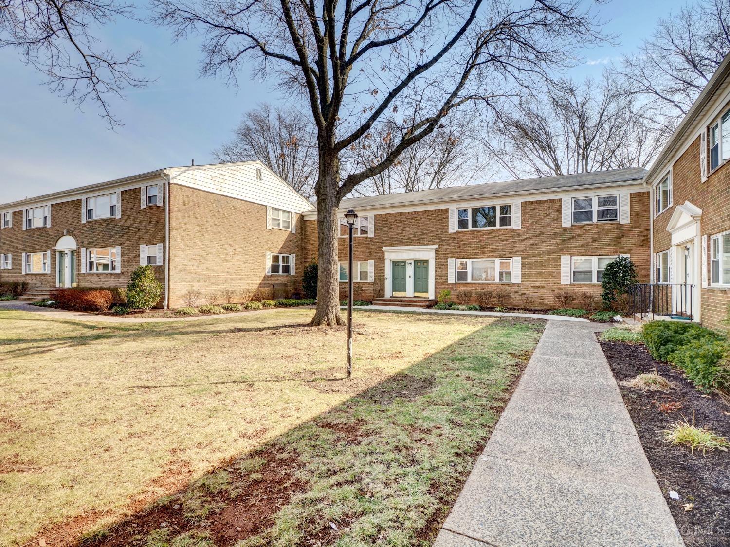 57 Judson Street, Unit 10B Edison, NJ 08837 - Photo 4 of 25 a view of a white house with a yard and sitting area