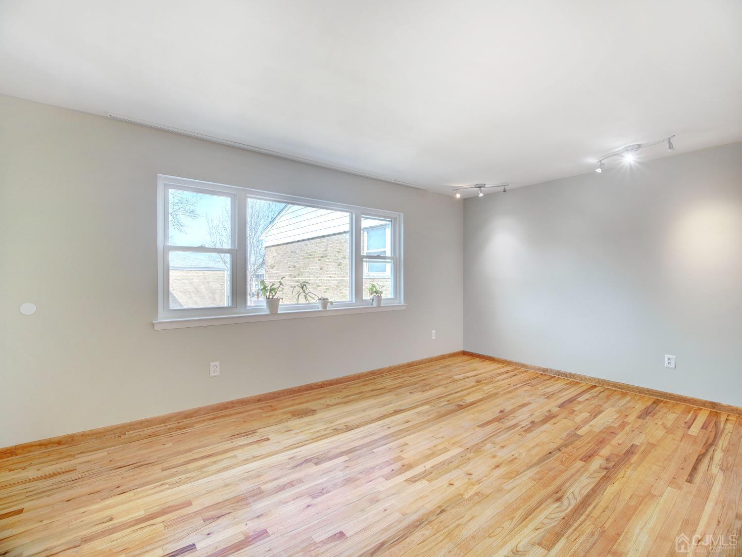 57 Judson Street, Unit 10B Edison, NJ 08837 - Photo 6 of 25 an empty room with wooden floor and windows