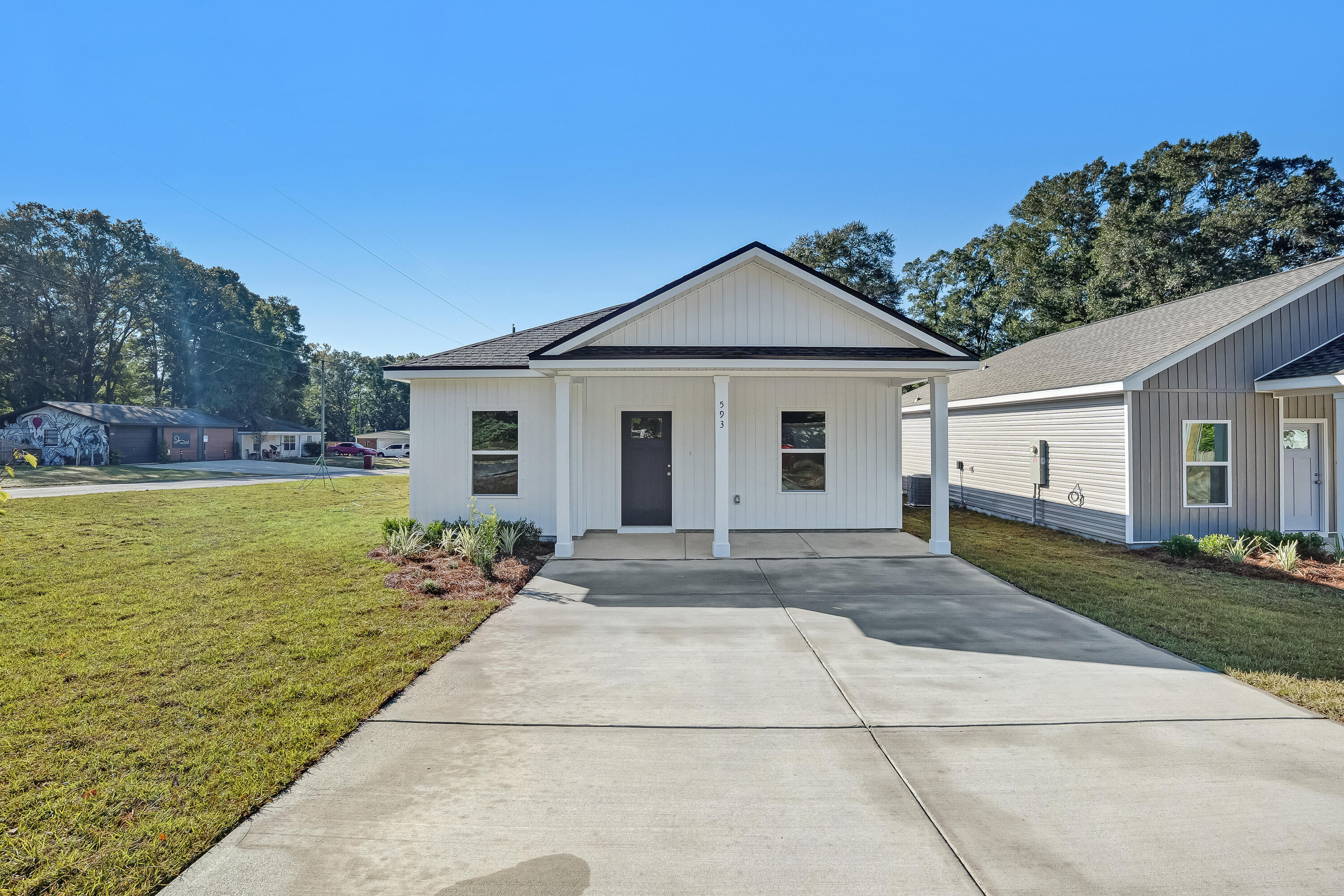593 Brock Avenue Crestview, FL 32539 - Photo 1 of 19 a front view of a house with garden