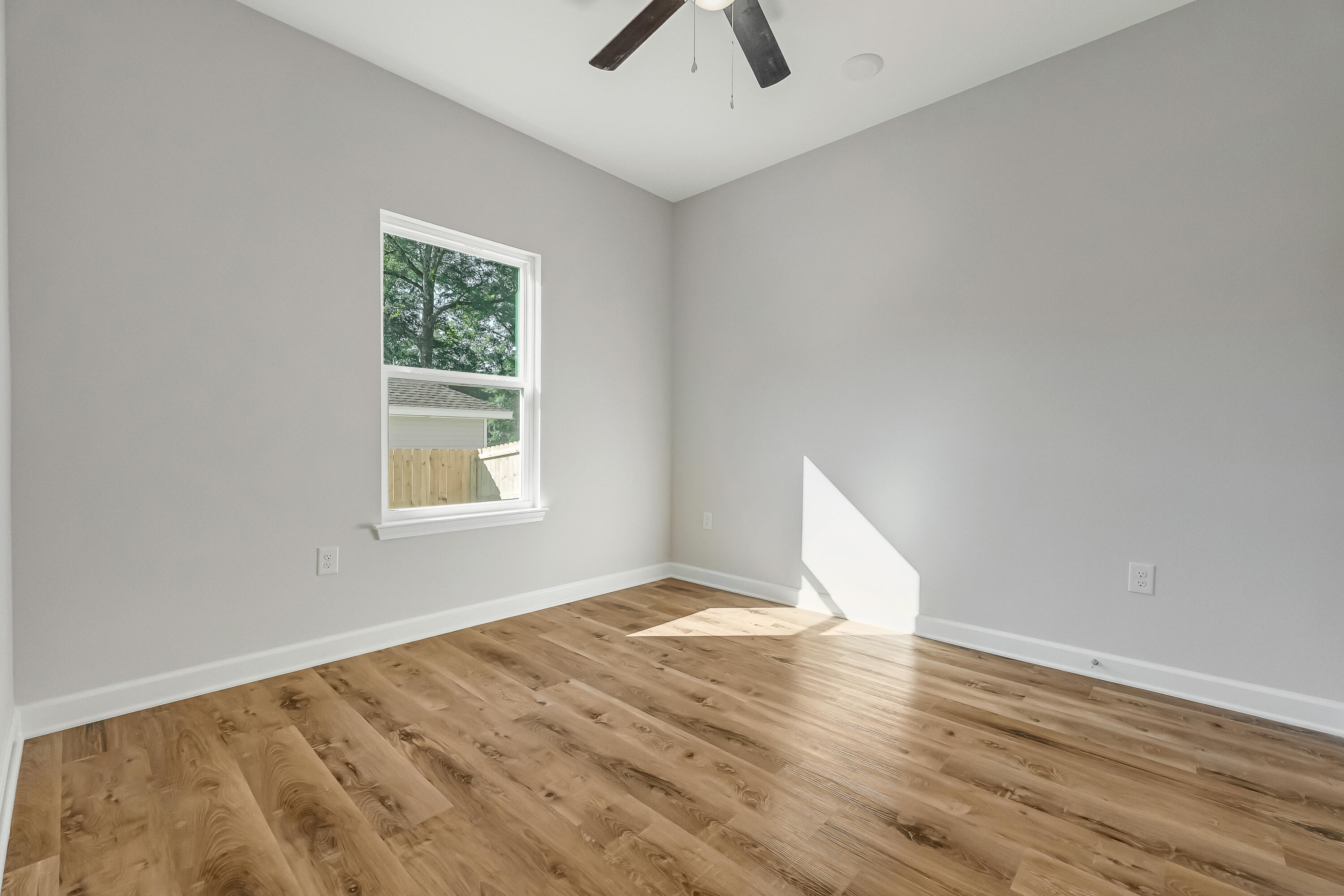 593 Brock Avenue Crestview, FL 32539 - Photo 14 of 19 wooden floor in an empty room with a window