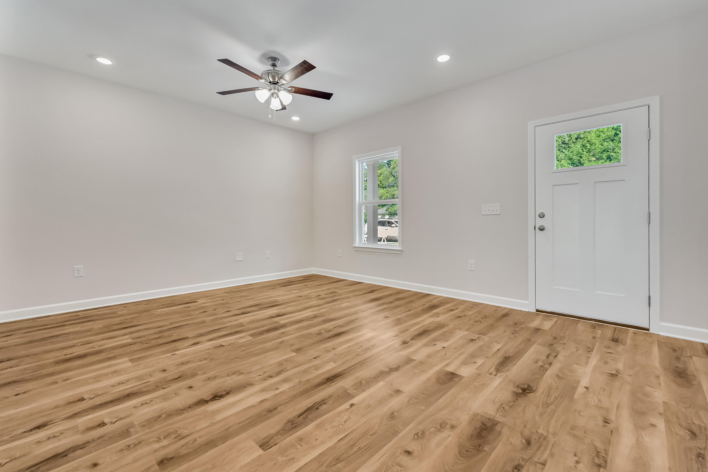 593 Brock Avenue Crestview, FL 32539 - Photo 4 of 19 wooden floor in an empty room with a window