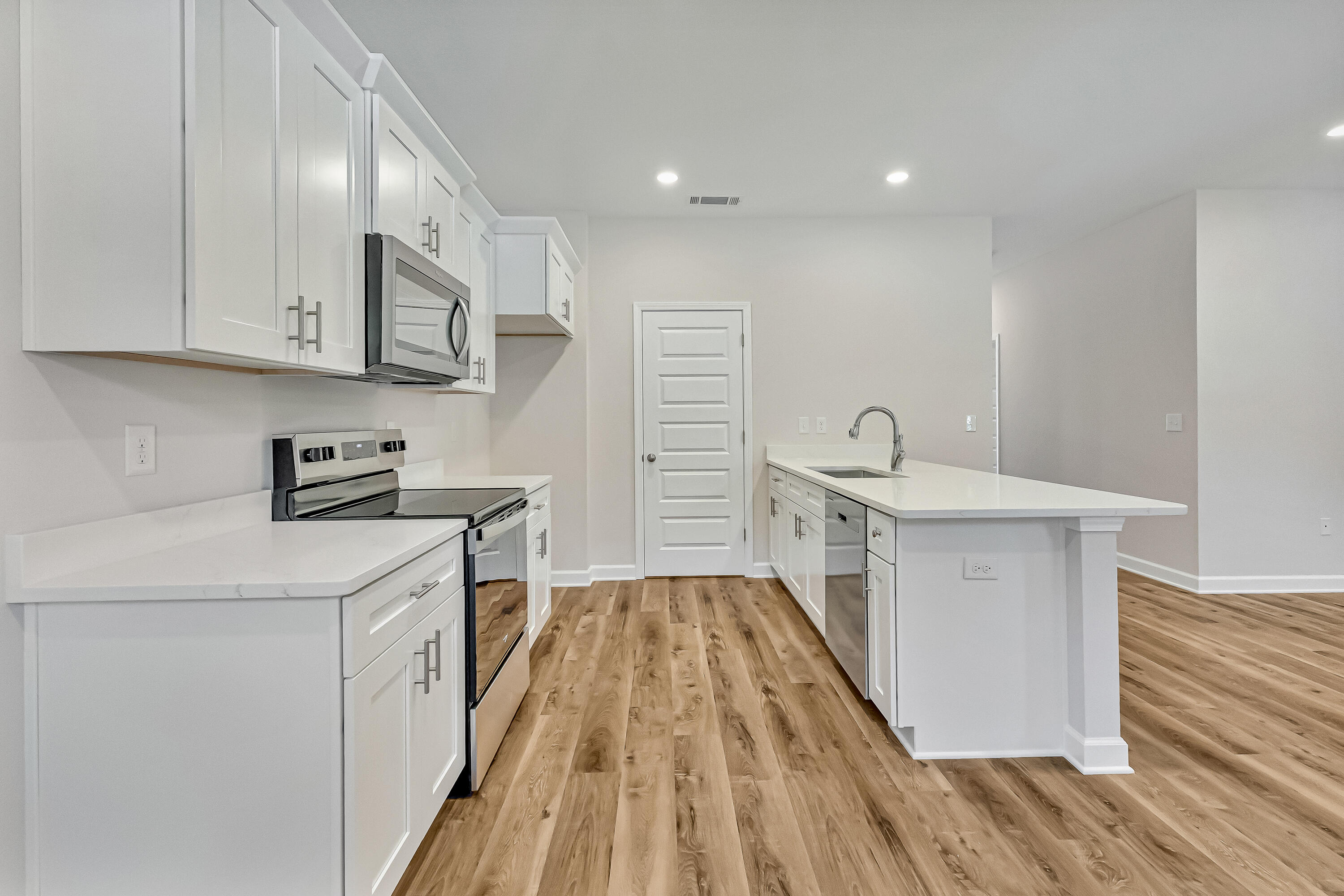 593 Brock Avenue Crestview, FL 32539 - Photo 8 of 19 a kitchen with cabinets and wooden floor