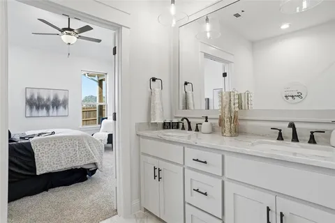 a en suite bathroom with double sink and a mirror