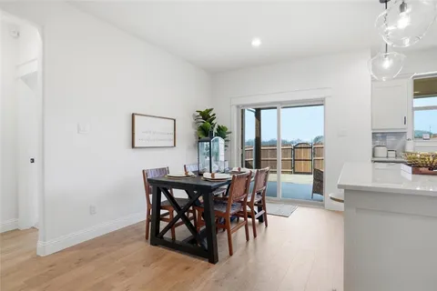 a view of a dining room with furniture and a large window