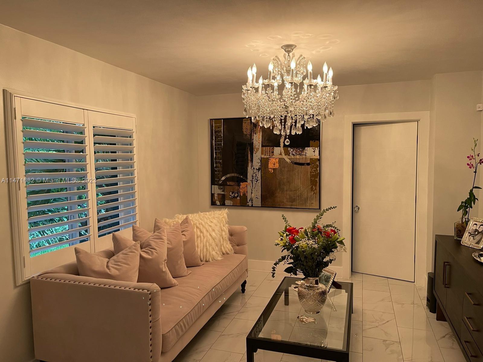 200 Southwest 30th Avenue Miami, FL 33135 - Photo 13 of 20 a living room with furniture and a chandelier