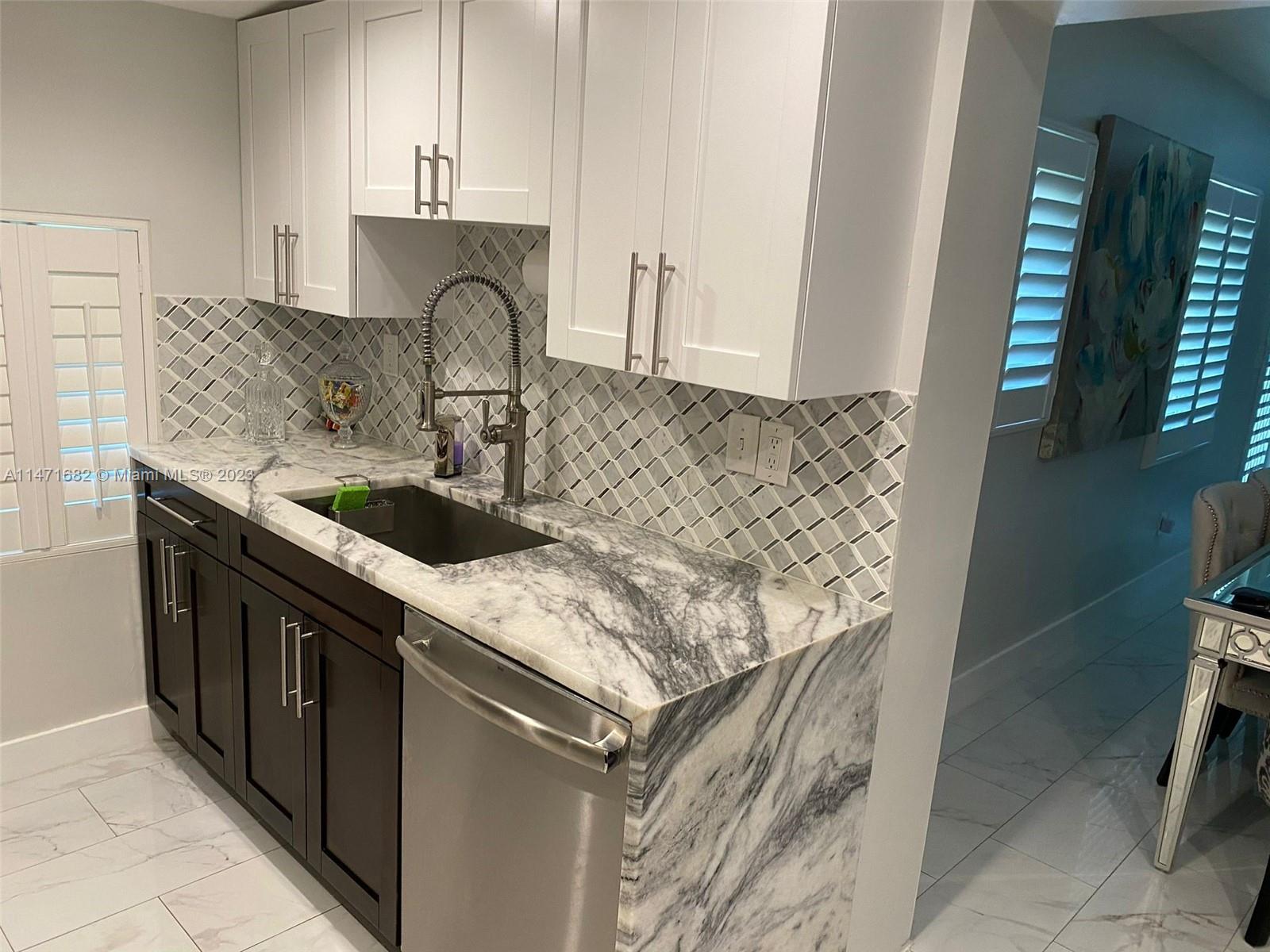 200 Southwest 30th Avenue Miami, FL 33135 - Photo 16 of 20 a kitchen with a sink and a stove top oven