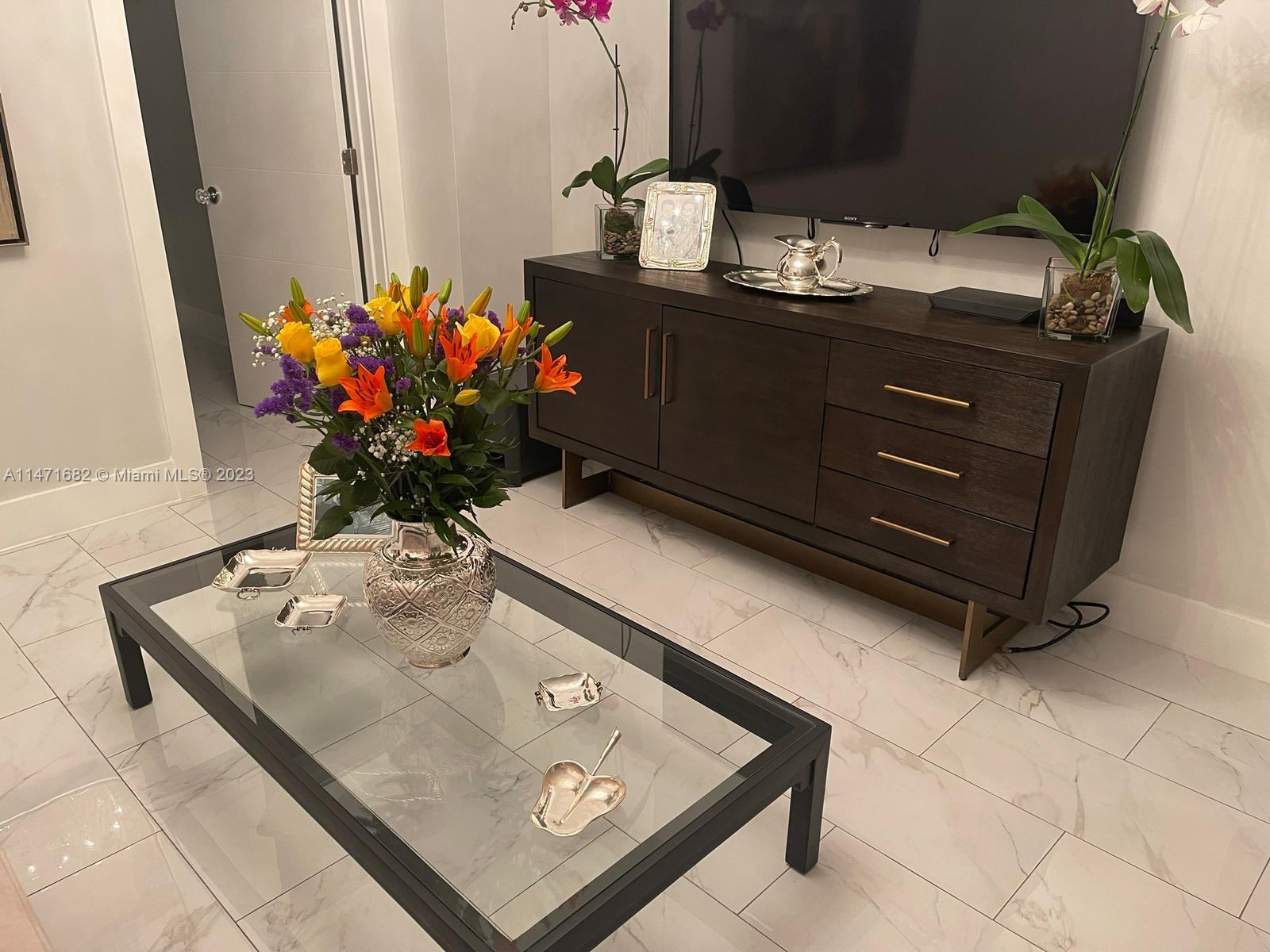 200 Southwest 30th Avenue Miami, FL 33135 - Photo 9 of 20 a room with a table potted plant and cabinets