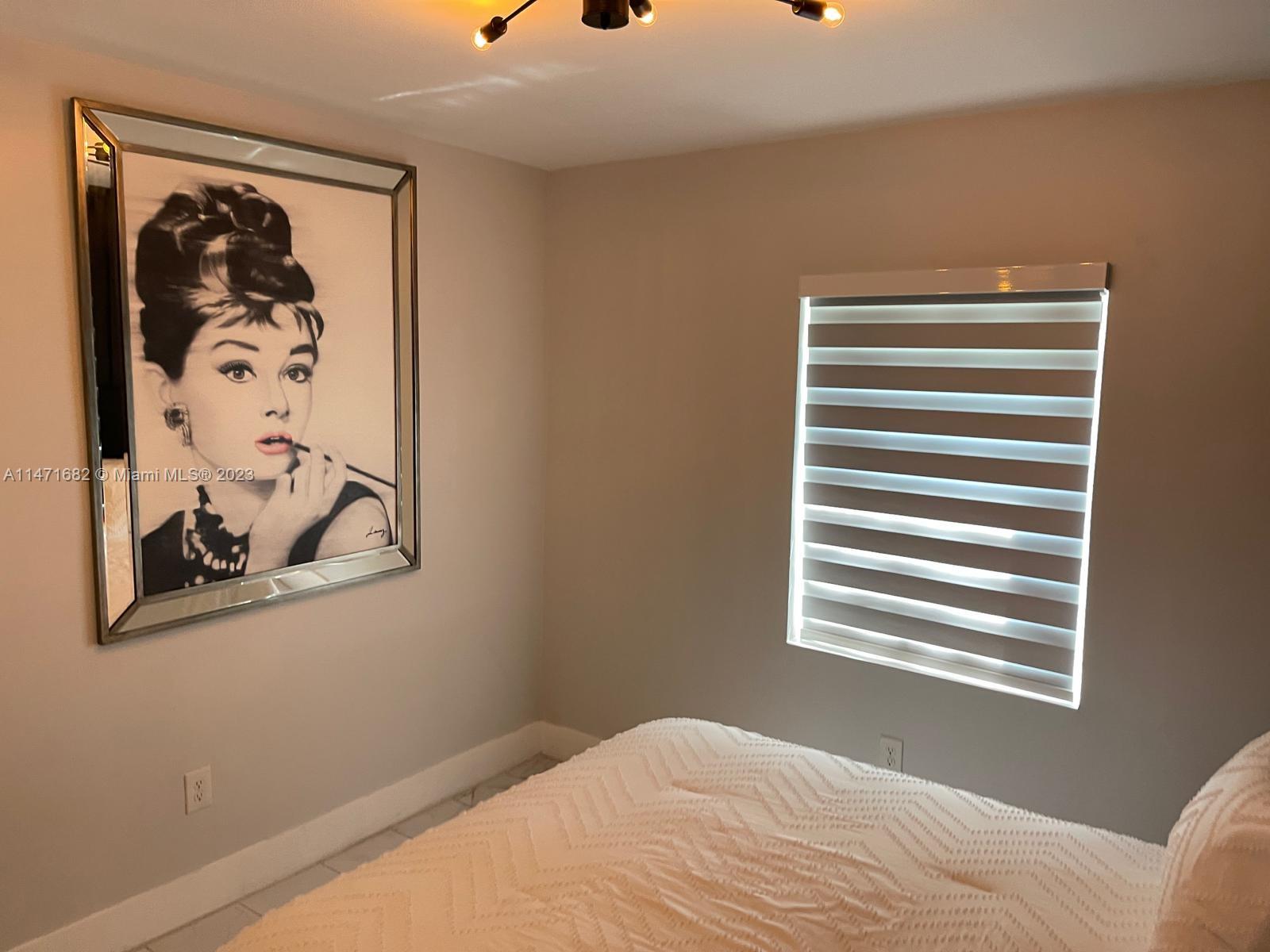 200 Southwest 30th Avenue Miami, FL 33135 - Photo 10 of 20 a bedroom with a bed and wall painting