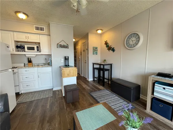 a view of kitchen with cabinets and wooden floor