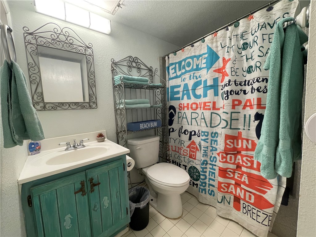 3938 Surfside Boulevard, Unit 3344 Corpus Christi, TX 78402 - Photo 24 of 34 a bathroom with a sink toilet and shower