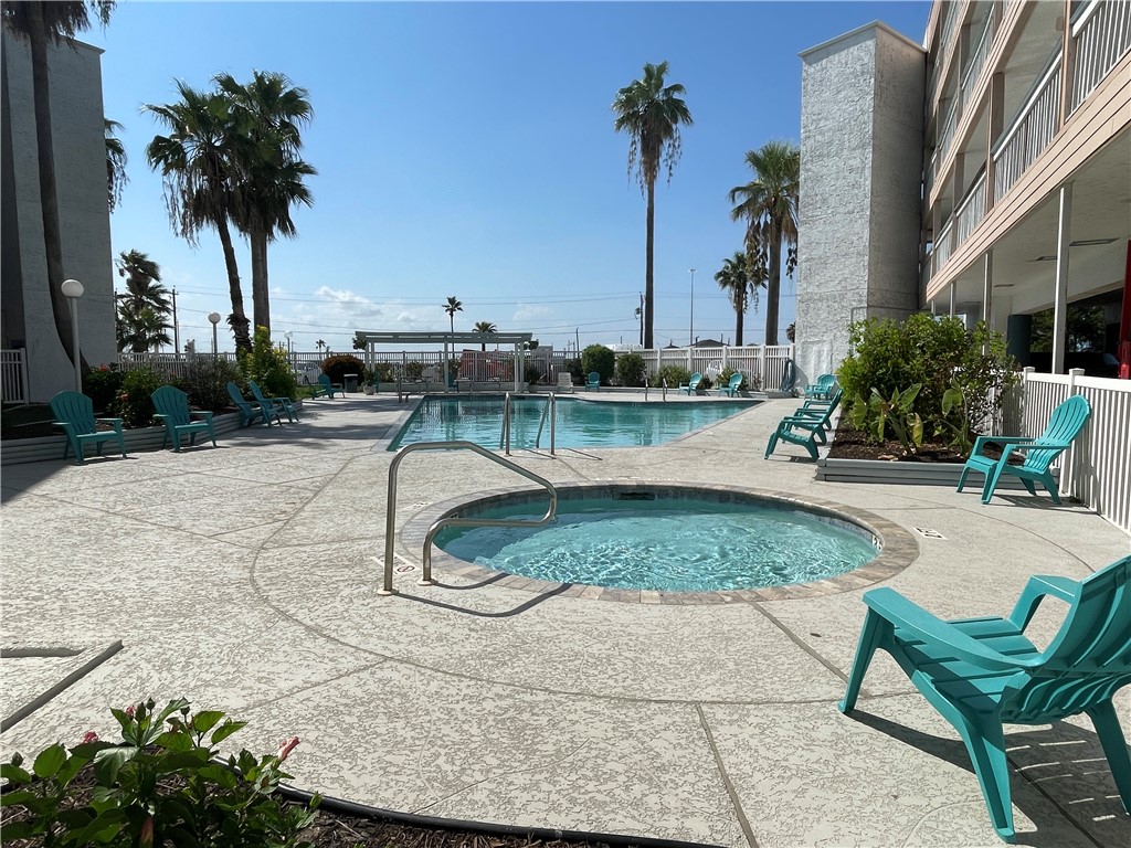 3938 Surfside Boulevard, Unit 3344 Corpus Christi, TX 78402 - Photo 31 of 34 a swimming pool with outdoor seating and yard