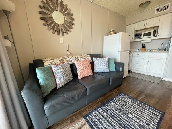 a living room with furniture and a kitchen view