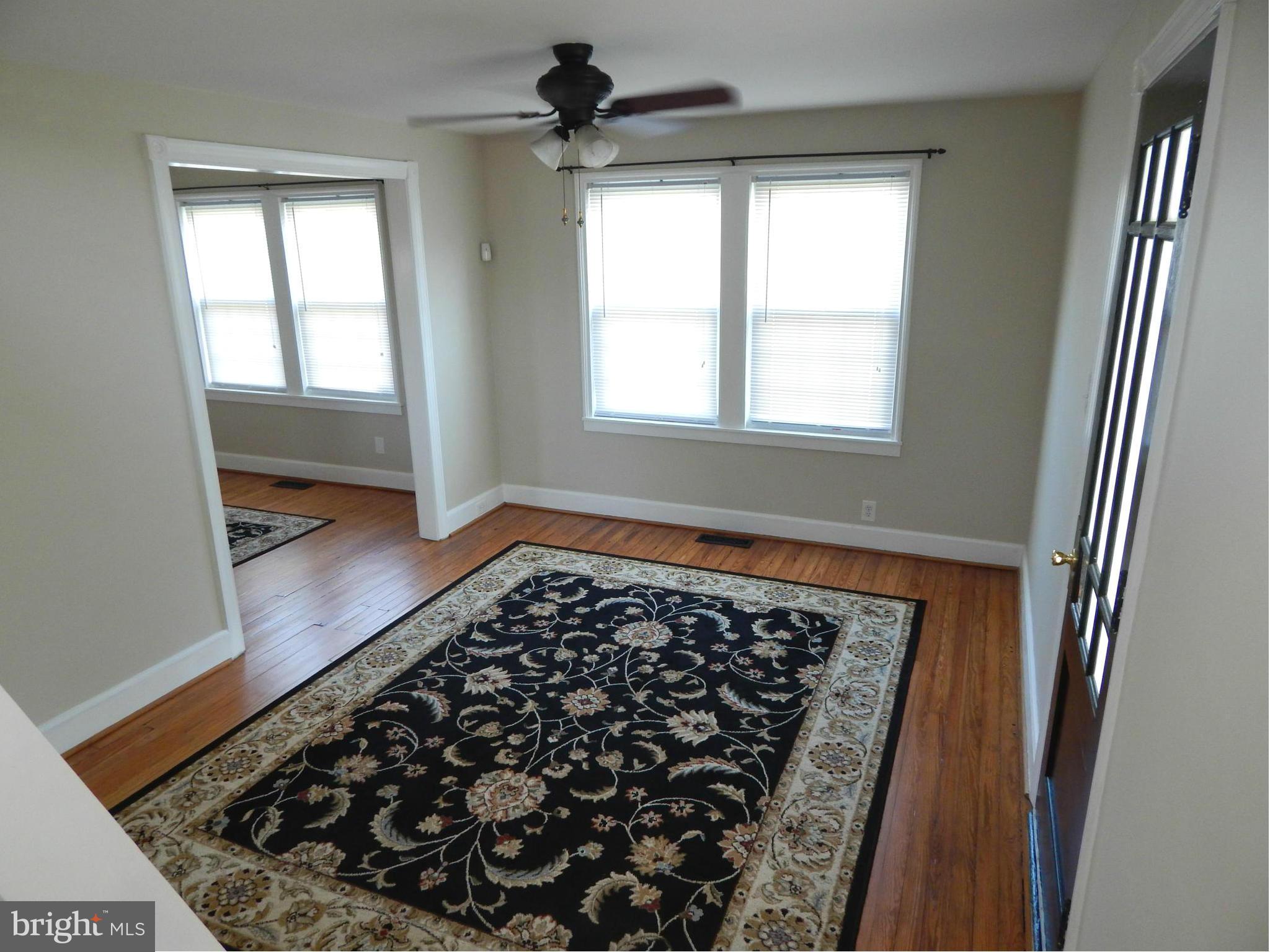 25 Kinship Road Dundalk, MD 21222 - Photo 3 of 30 walk in closet with wooden floor in front of a living room