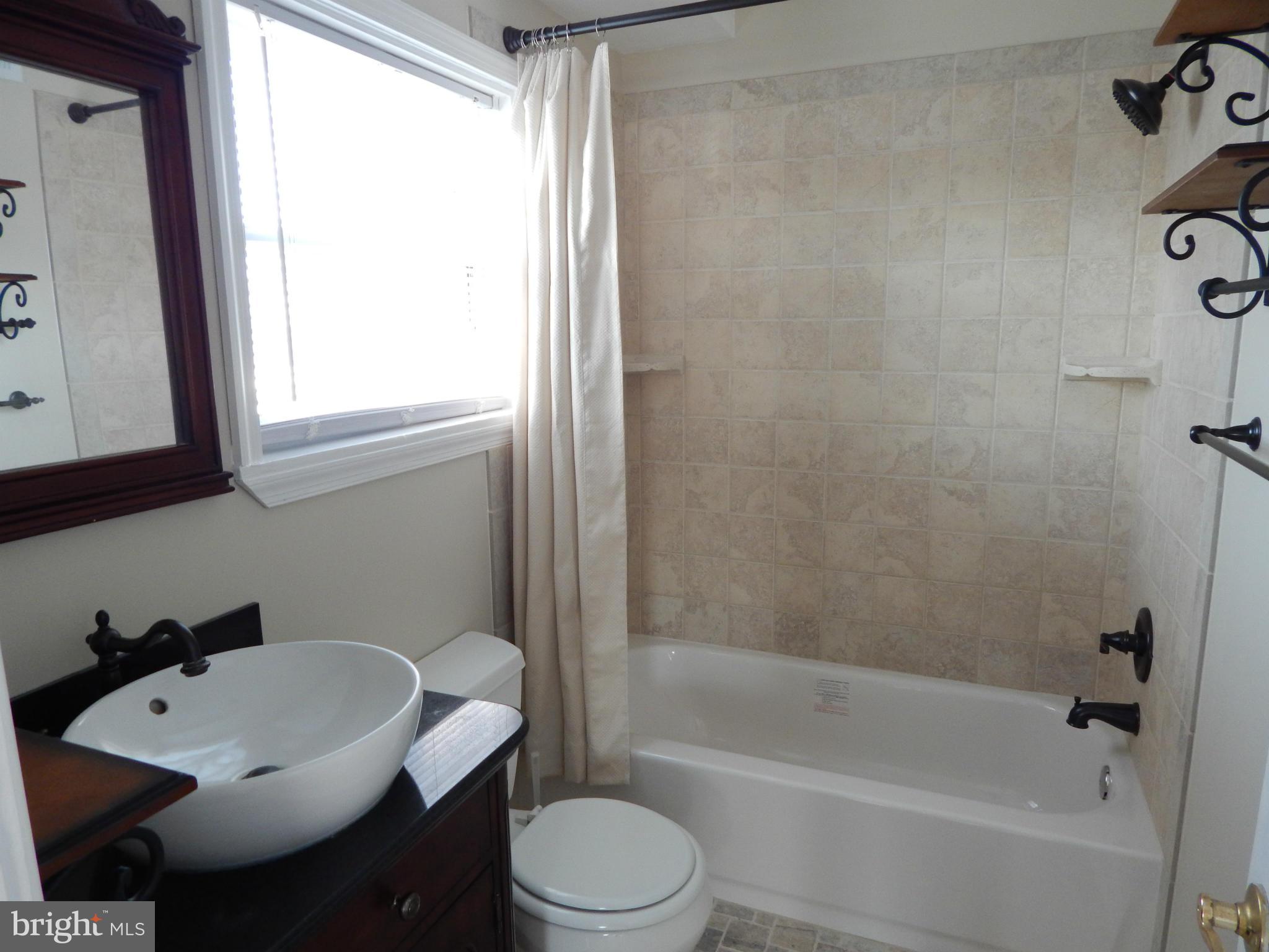 25 Kinship Road Dundalk, MD 21222 - Photo 10 of 30 a bathroom with a sink toilet and shower