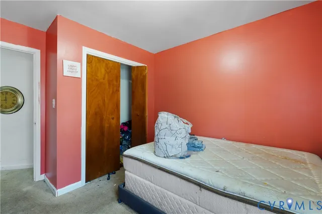 a bedroom with a bed and a dresser