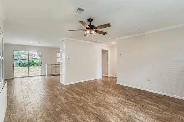 wooden floor in an empty room with a window