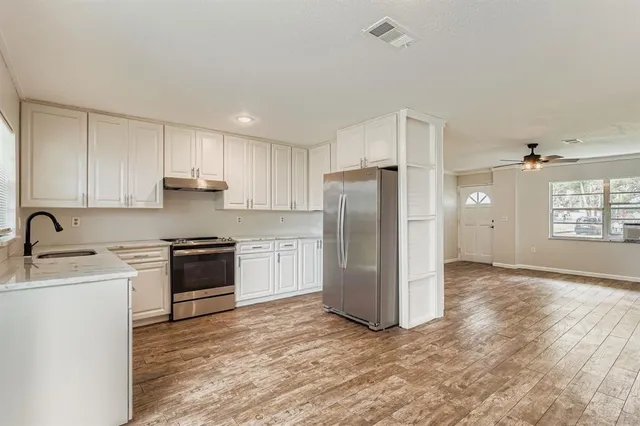 a kitchen with a refrigerator and a sink