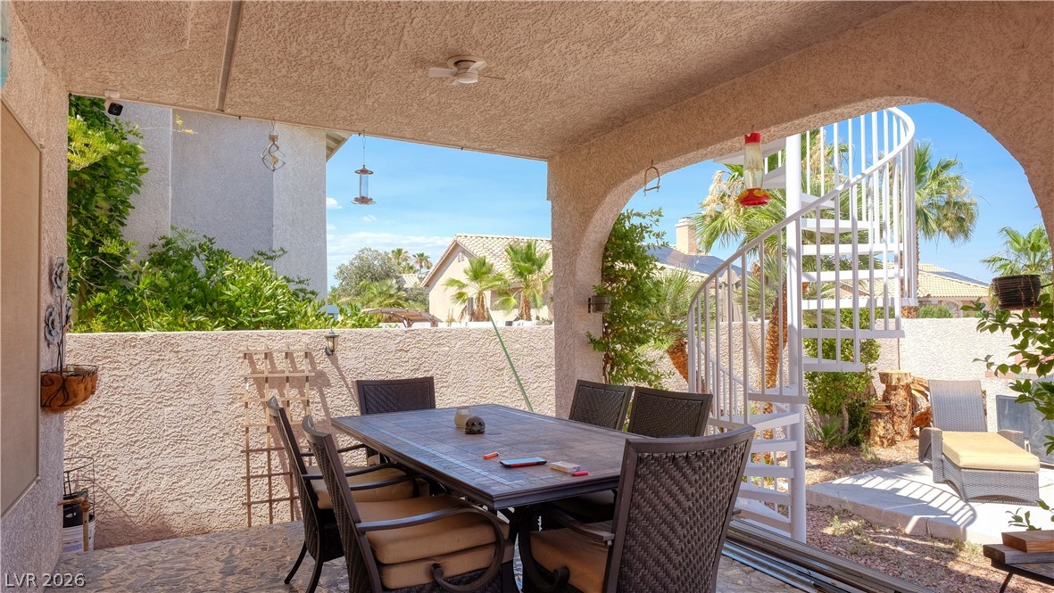 3704 North Campbell Road Las Vegas, NV 89129 - Photo 17 of 38 A breezy outdoor dining area with a spiral staircase to a rooftop deck awaits, perfect for entertaining.