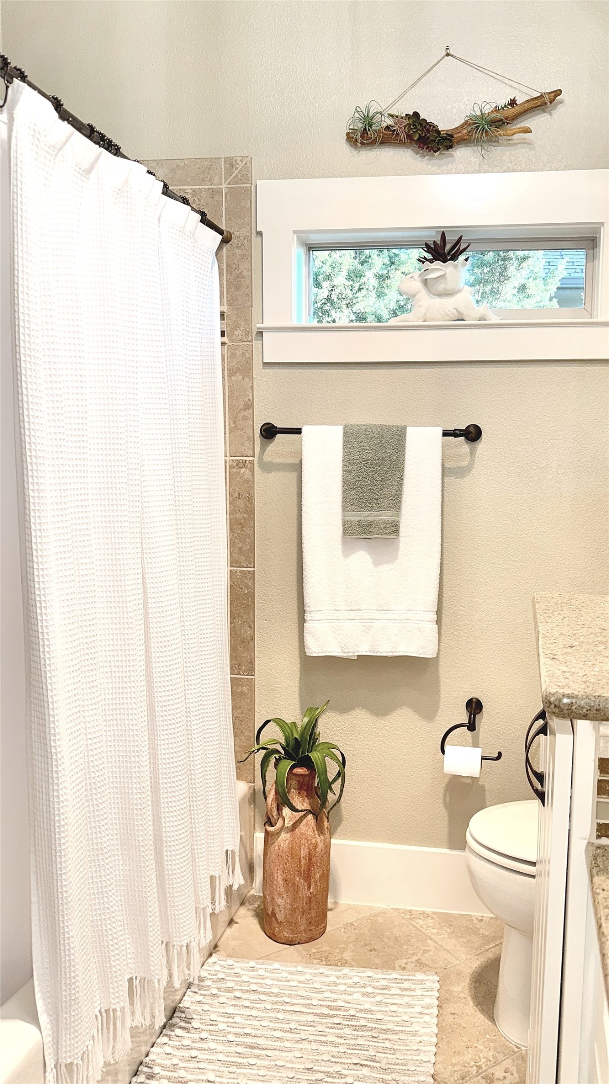 261 Barber Drive Wimberley, TX 78676 - Photo 16 of 37 Bathroom featuring vanity, shower / tub combo with curtain, and light tile patterned flooring
