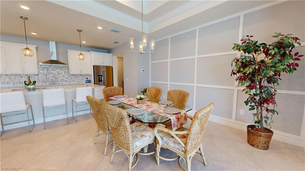 6162 Nobility Way Avenue Immokalee, FL 34142 - Photo 13 of 50 a view of a dining room with furniture and potted plant