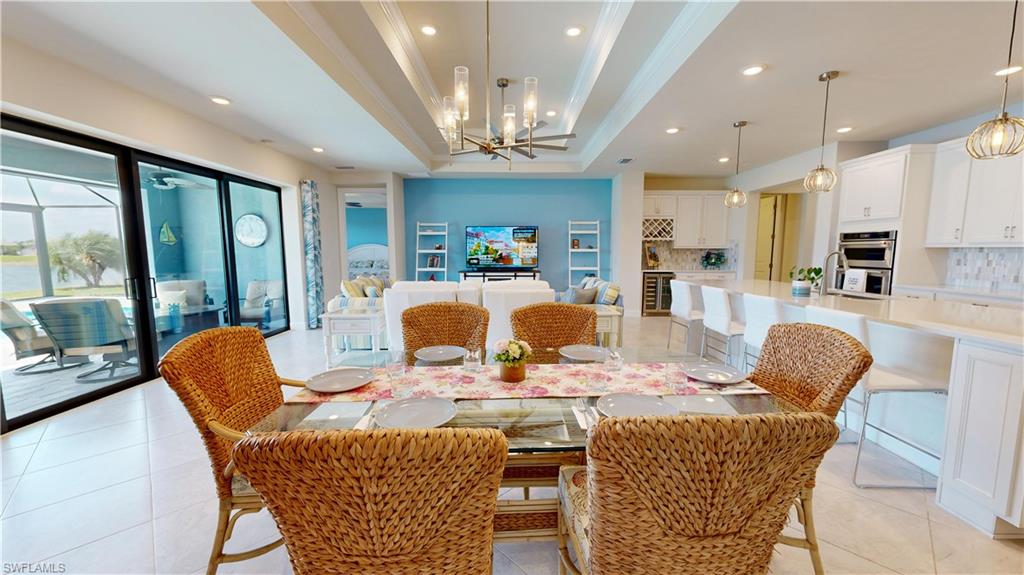 6162 Nobility Way Avenue Immokalee, FL 34142 - Photo 14 of 50 a view of a dining room with furniture a chandelier and wooden floor