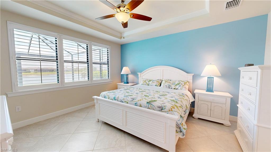 6162 Nobility Way Avenue Immokalee, FL 34142 - Photo 32 of 50 a bedroom with a bed and a chandelier