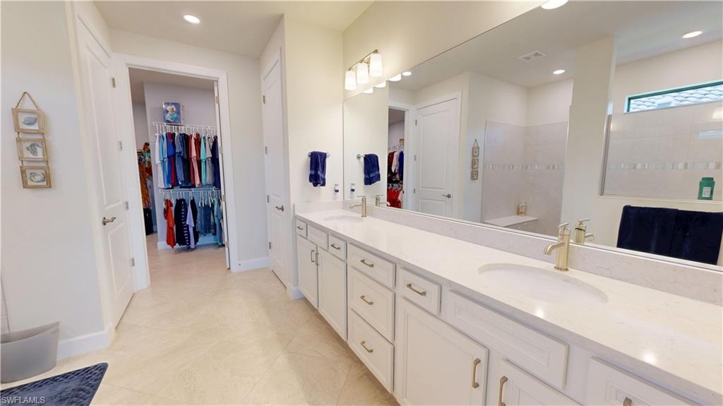 6162 Nobility Way Avenue Immokalee, FL 34142 - Photo 35 of 50 a bathroom with a double vanity sink and a mirror