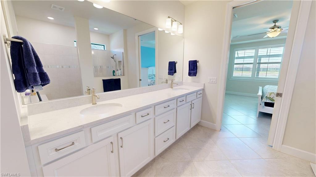 6162 Nobility Way Avenue Immokalee, FL 34142 - Photo 37 of 50 a spacious bathroom with a double vanity sink mirror and shower