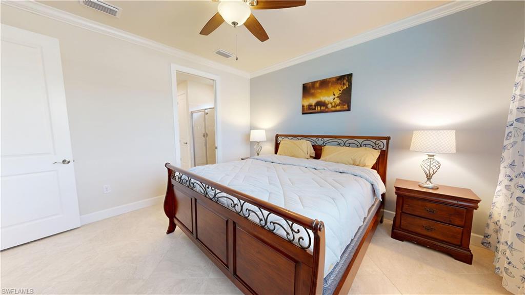 6162 Nobility Way Avenue Immokalee, FL 34142 - Photo 39 of 50 a bedroom with a bed and a chandelier