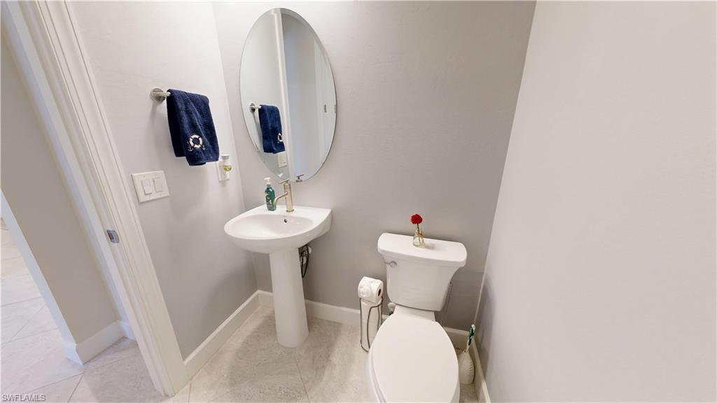 6162 Nobility Way Avenue Immokalee, FL 34142 - Photo 45 of 50 a bathroom with a toilet sink and mirror