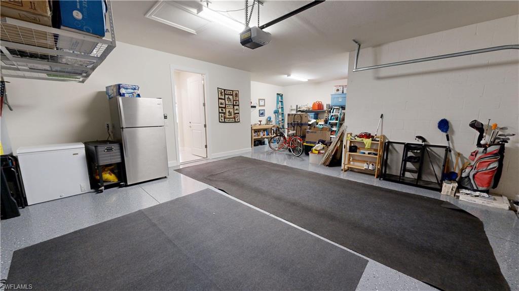 6162 Nobility Way Avenue Immokalee, FL 34142 - Photo 49 of 50 a view of a garage with a bike and wooden floor