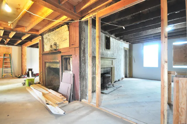 a view of an empty room with a fireplace
