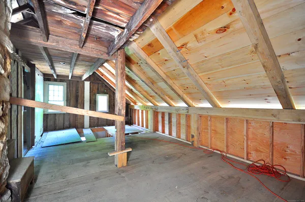 a bedroom with a large bed and a large window