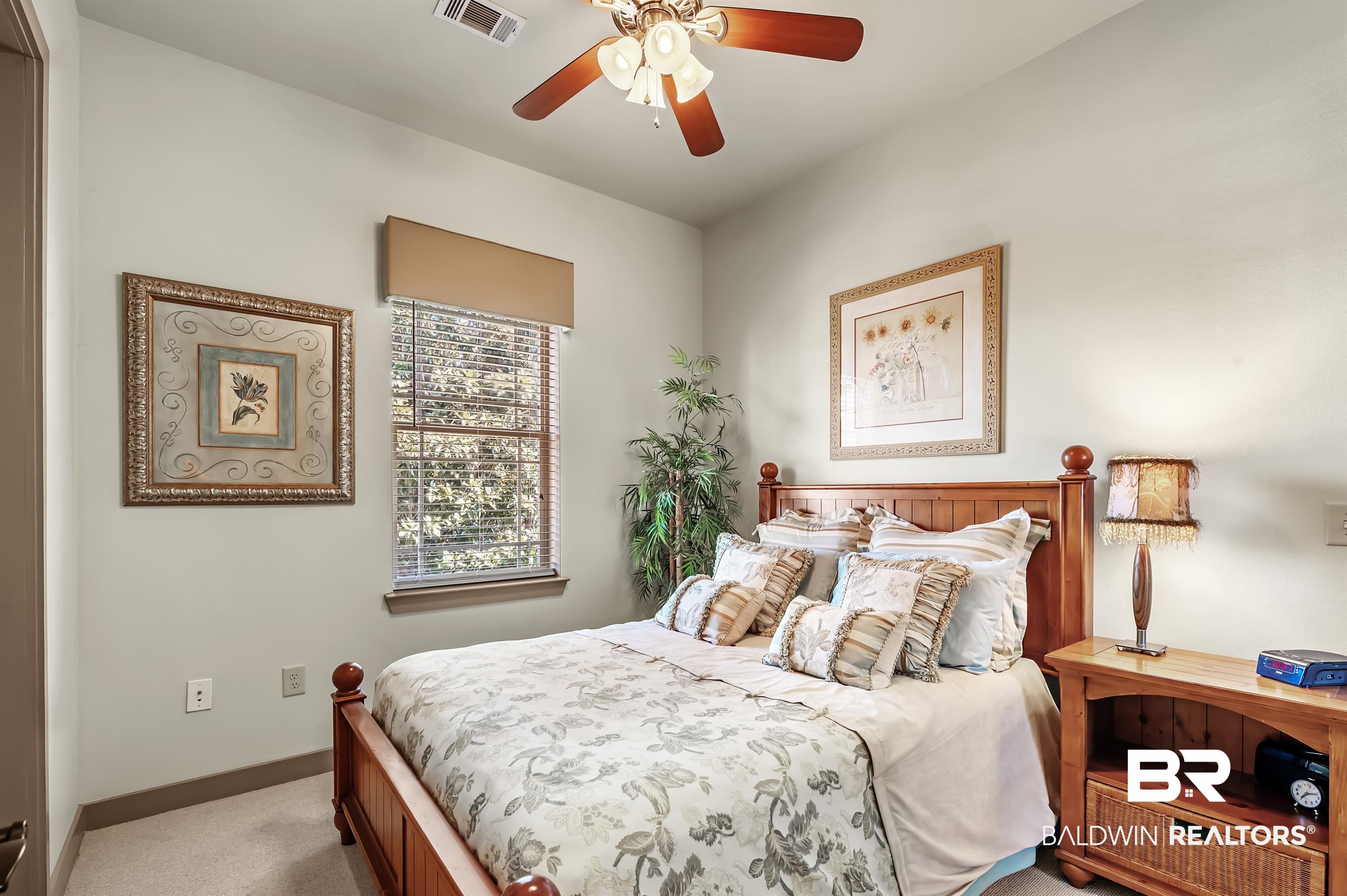 1430 Regency Road, Unit A301 Gulf Shores, AL 36542 - Photo 27 of 47 Carpeted bedroom with ceiling fan