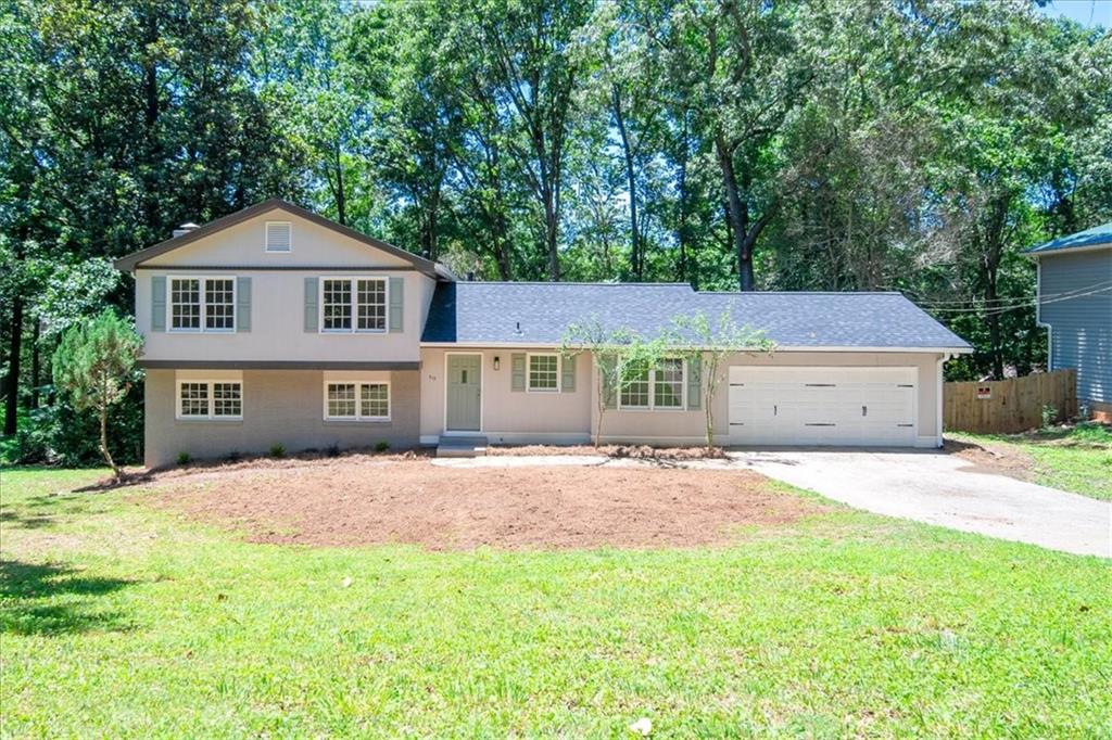 a big house with a big yard and large trees