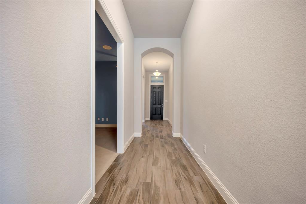 9820 Surveyor Road Little Elm, TX 75068 - Photo 13 of 40 a view of a hallway with wooden floor