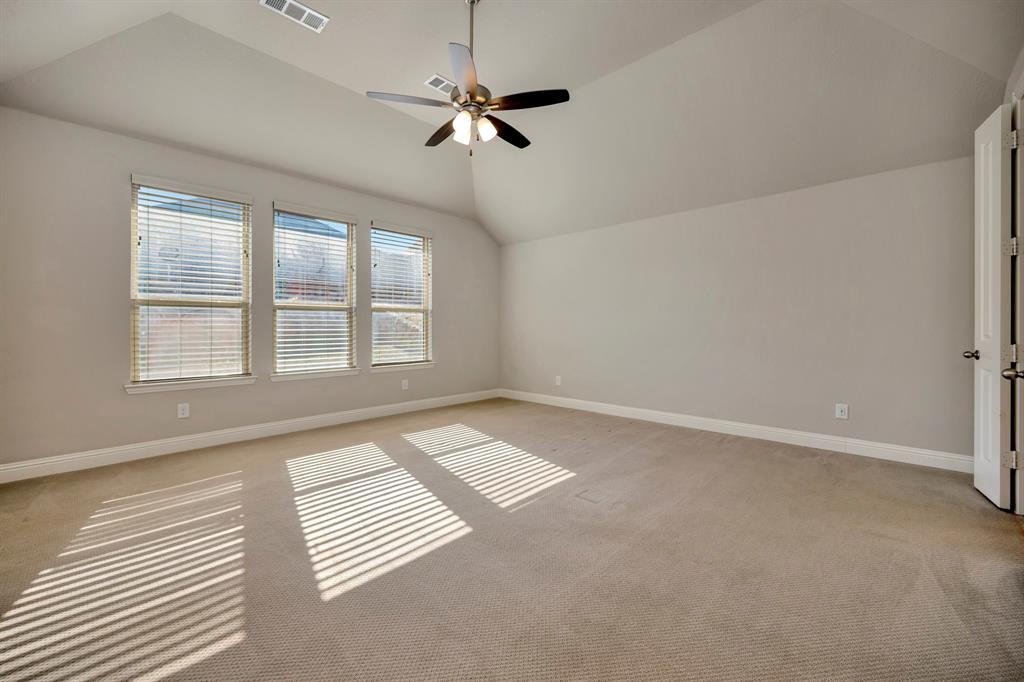 9820 Surveyor Road Little Elm, TX 75068 - Photo 16 of 40 an empty room with windows and ceiling fan