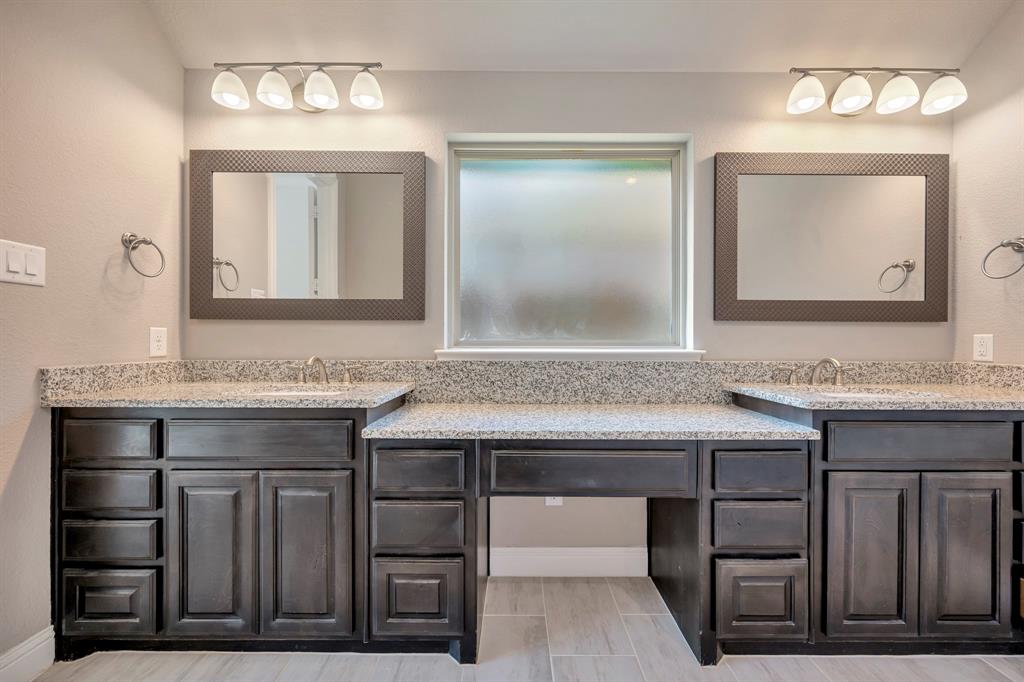 9820 Surveyor Road Little Elm, TX 75068 - Photo 17 of 40 a bathroom with a granite countertop sink and a mirror