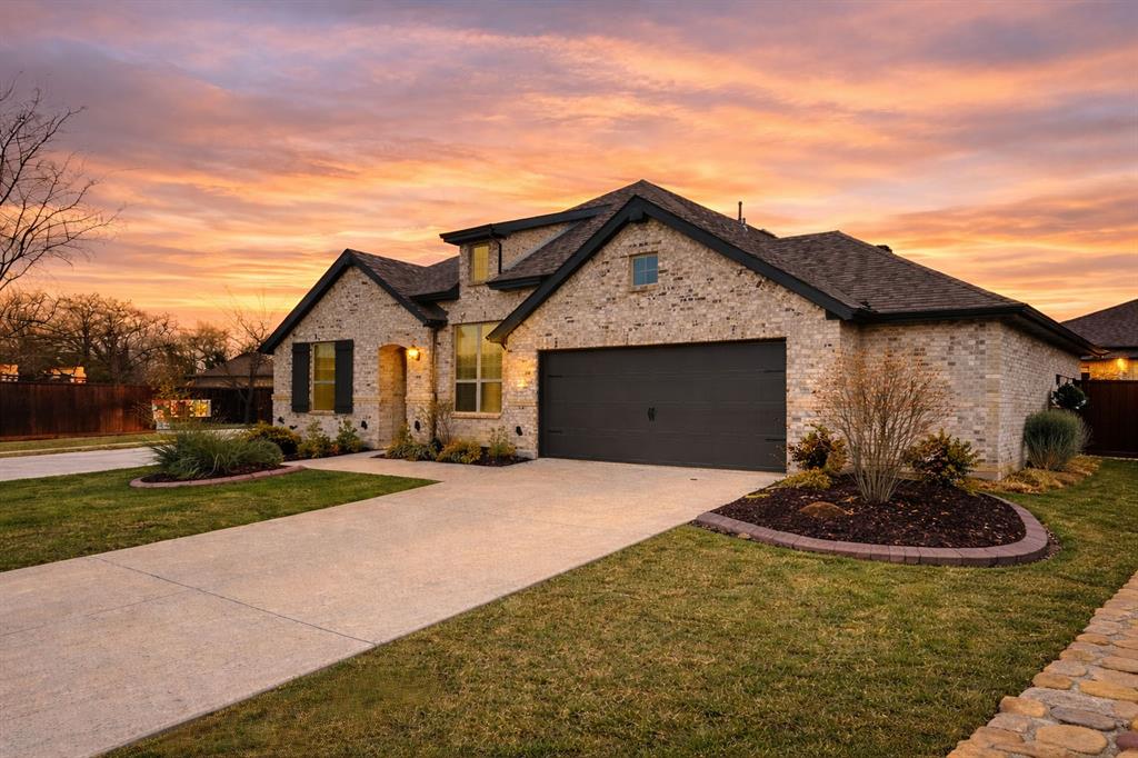 9820 Surveyor Road Little Elm, TX 75068 - Photo 2 of 40 French provincial home featuring driveway, brick siding, and an attached garage