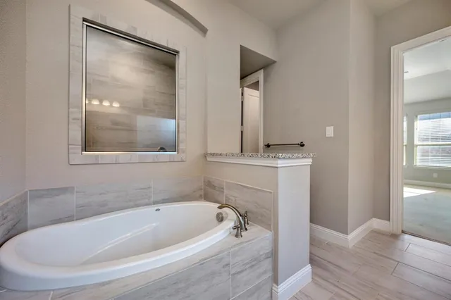 an empty room with windows and ceiling fan