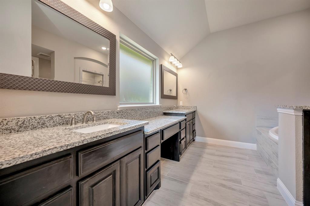 9820 Surveyor Road Little Elm, TX 75068 - Photo 18 of 40 a bathroom with a granite countertop sink and a mirror