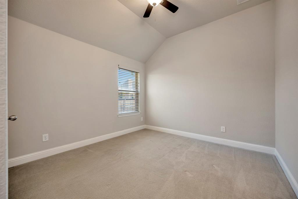 9820 Surveyor Road Little Elm, TX 75068 - Photo 25 of 40 Carpeted spare room with ceiling fan and lofted ceiling