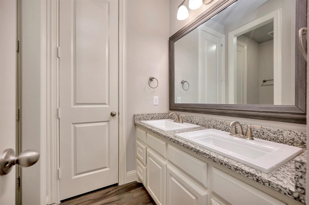 9820 Surveyor Road Little Elm, TX 75068 - Photo 27 of 40 Bathroom featuring double vanity and dark wood-style floors
