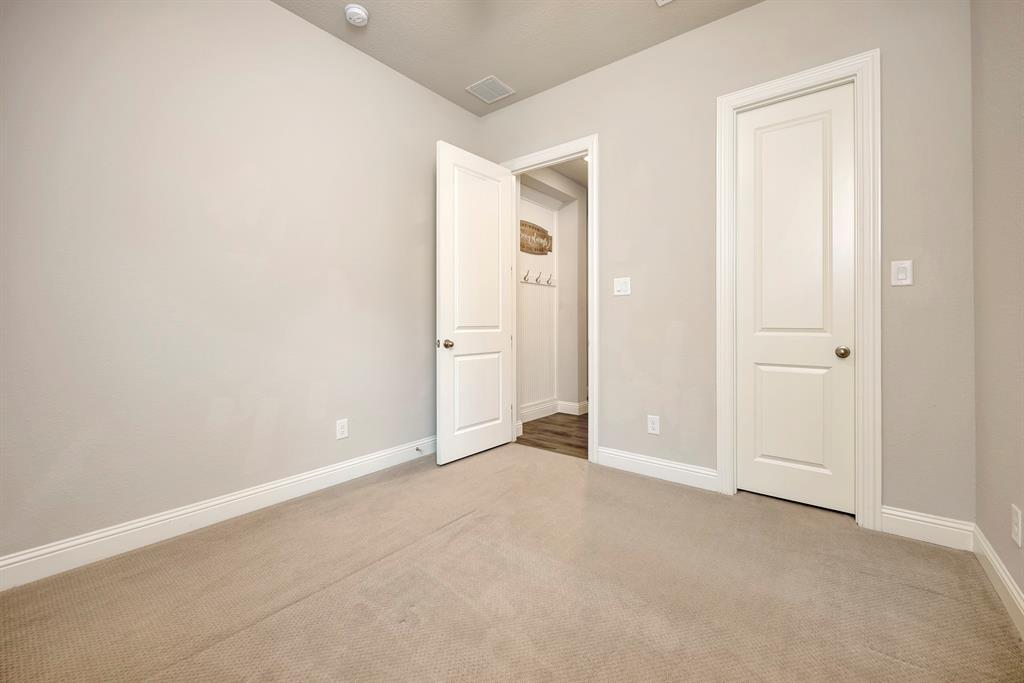 9820 Surveyor Road Little Elm, TX 75068 - Photo 32 of 40 Unfurnished bedroom featuring baseboards and carpet flooring