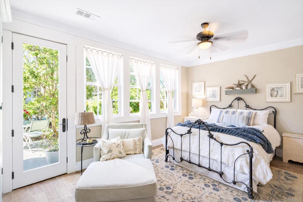 162 Jupiter Street Encinitas, CA 92024 - Photo 11 of 31 a bedroom with a large bed and a chandelier