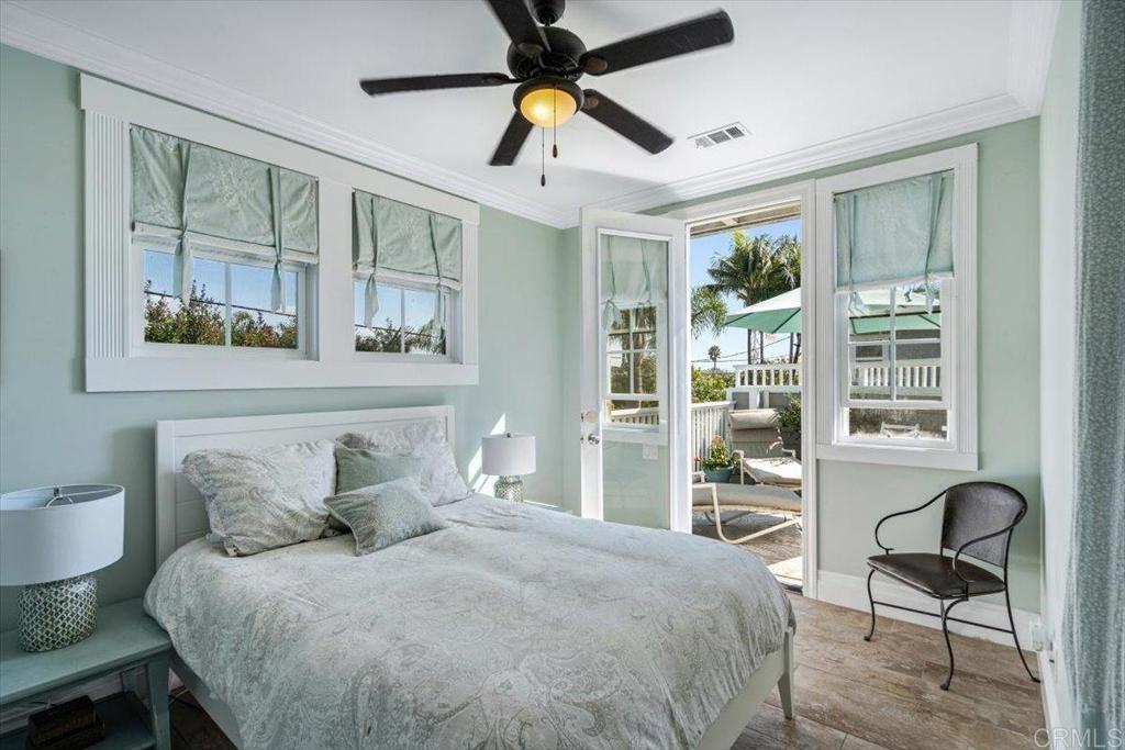 162 Jupiter Street Encinitas, CA 92024 - Photo 19 of 31 a bedroom with a bed and a chandelier