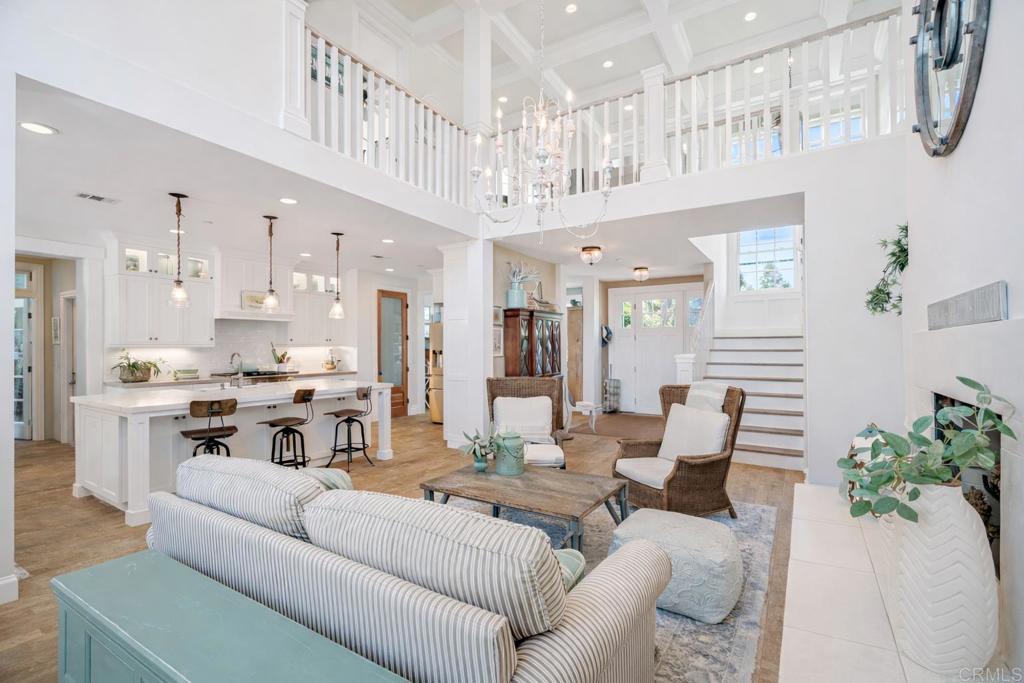 162 Jupiter Street Encinitas, CA 92024 - Photo 4 of 31 a living room with furniture kitchen view and a chandelier