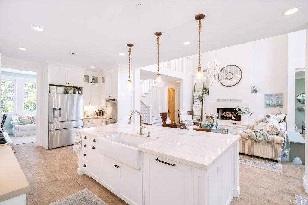162 Jupiter Street Encinitas, CA 92024 - Photo 6 of 31 a large kitchen with kitchen island a large counter top space a sink stainless steel appliances and cabinets